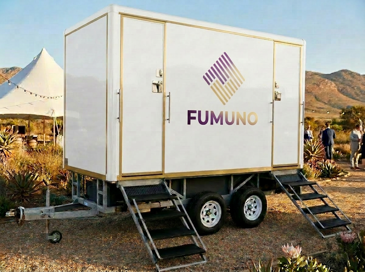 VIP portable toilet trailer at an upscale outdoor wedding venue